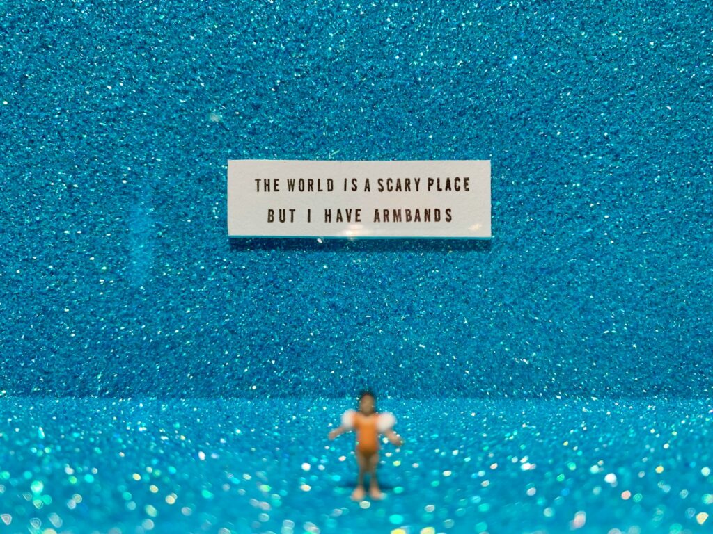 The World is Scary Place But I Have Armbands sticker on blue surface